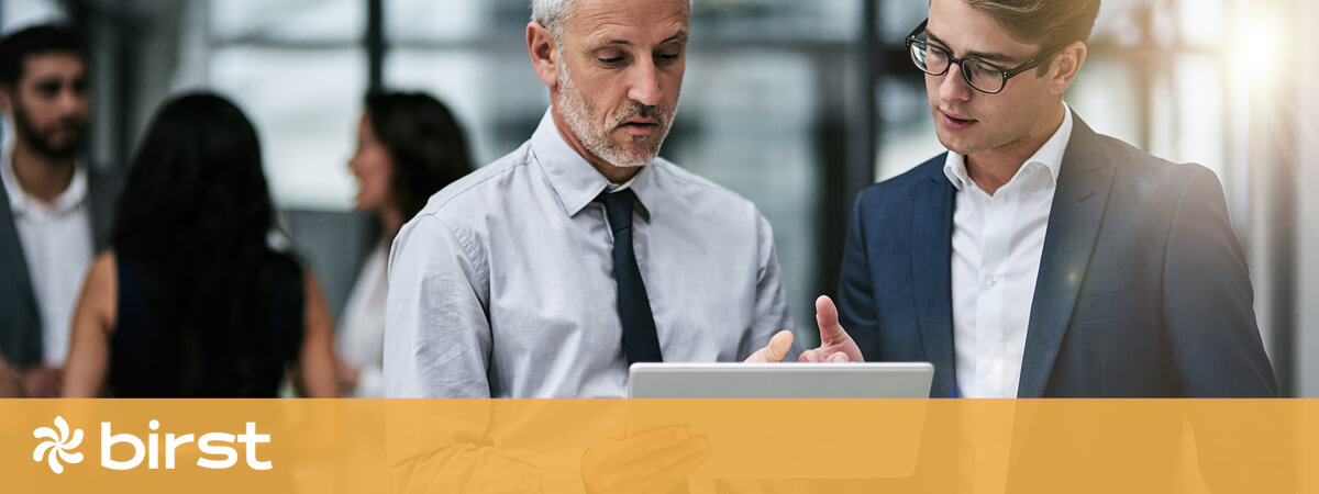 Two business colleagues reviewing content on an ipad
